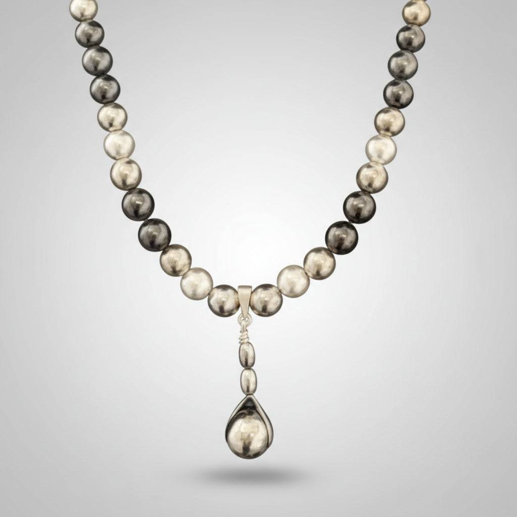 Necklace with black and white beads on a dark background